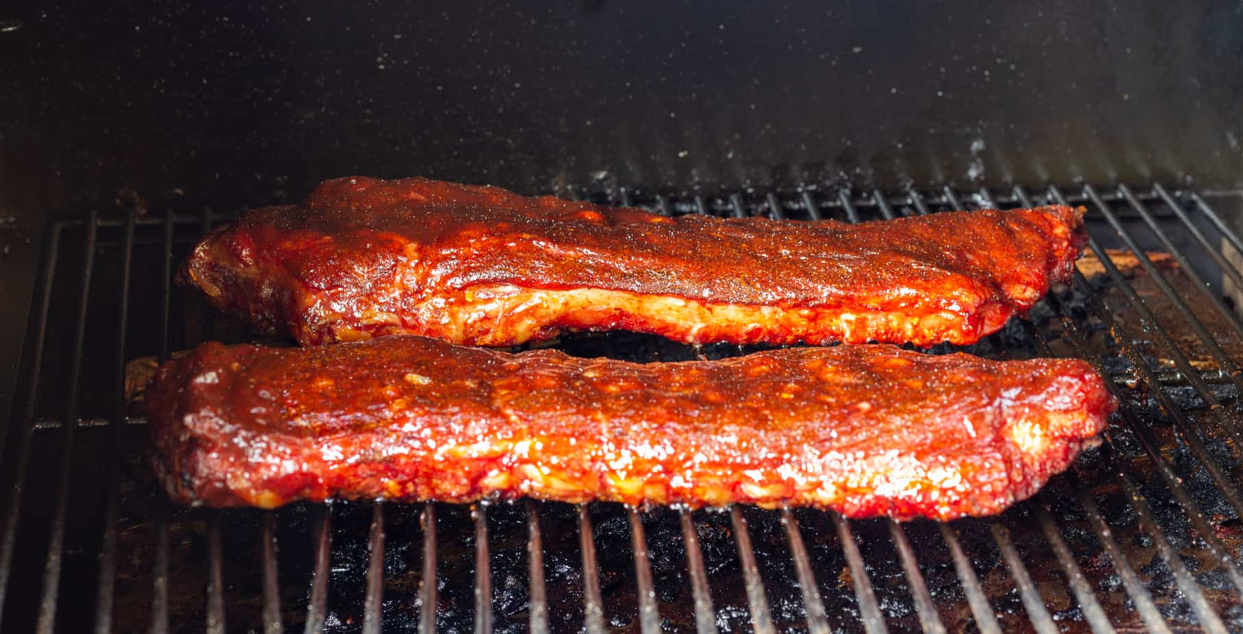 Spare ribs in a smoker with sauce