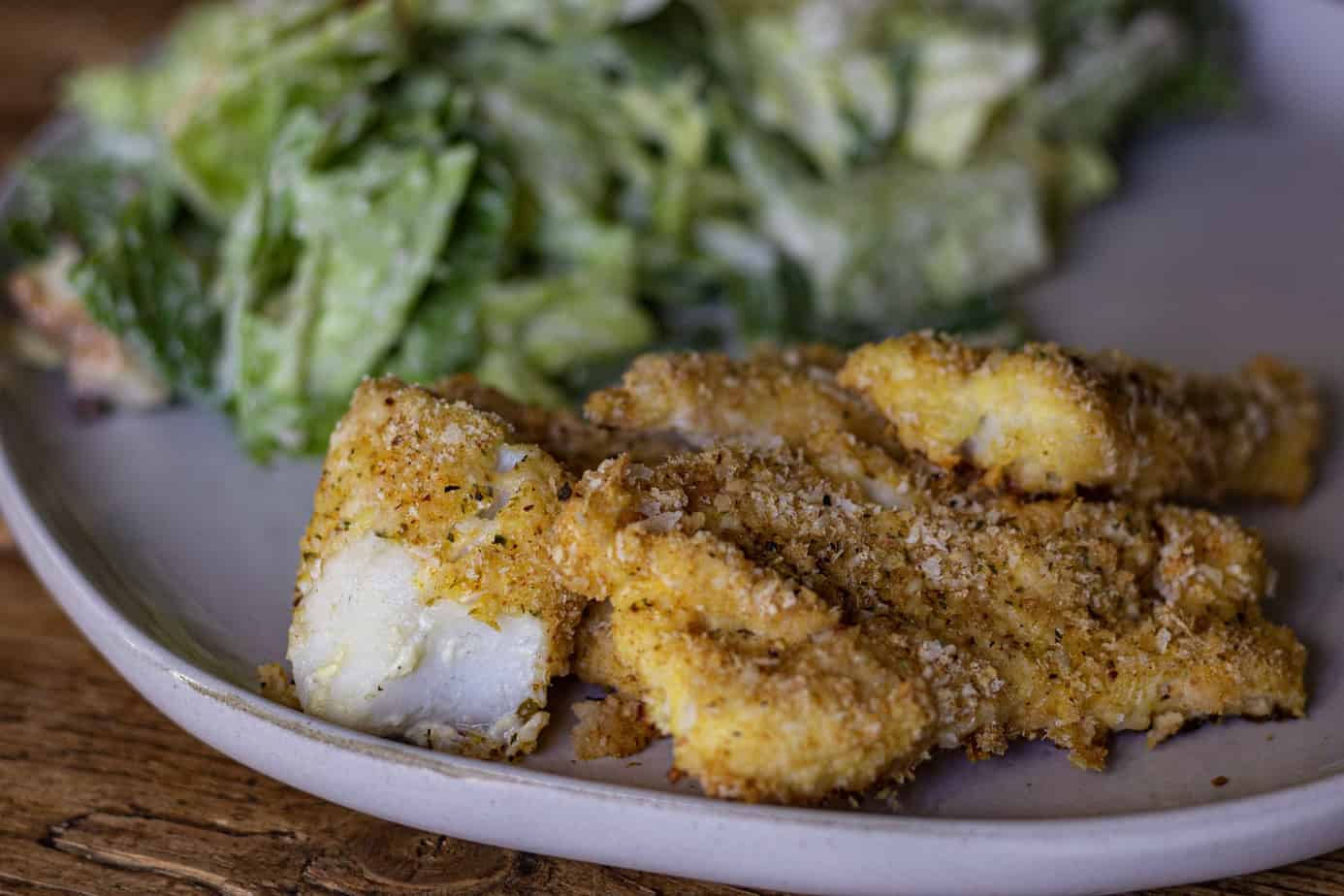 Traeger Walleye with a side salad on a plate