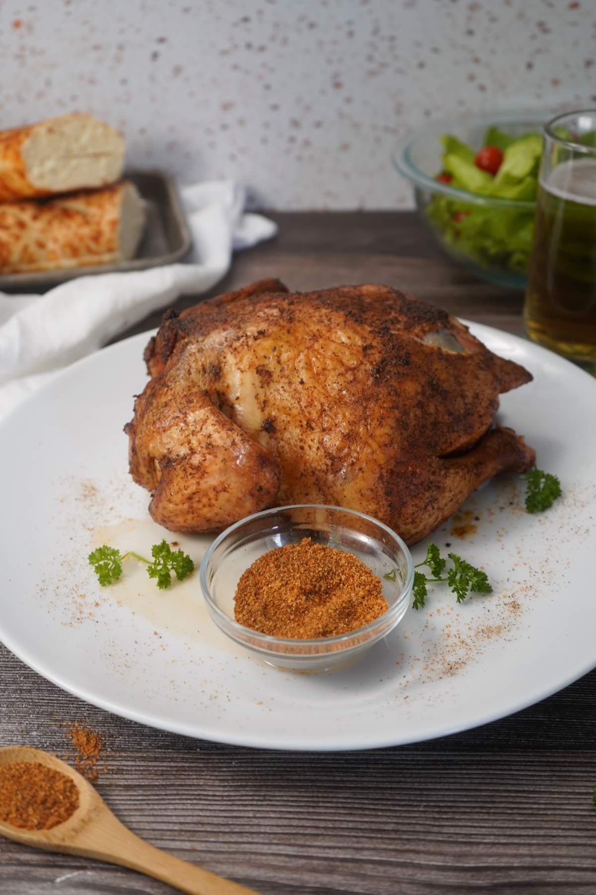 Whole chicken with seasonings on platter