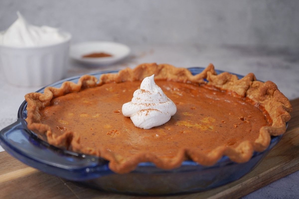 Smoked pumpkin pie in blue pie dish