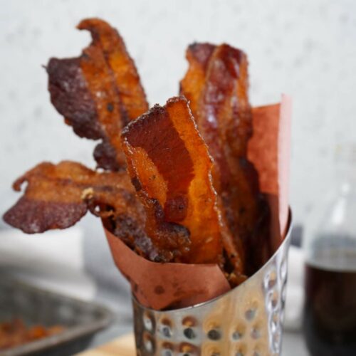 Candied bacon slices in holder.