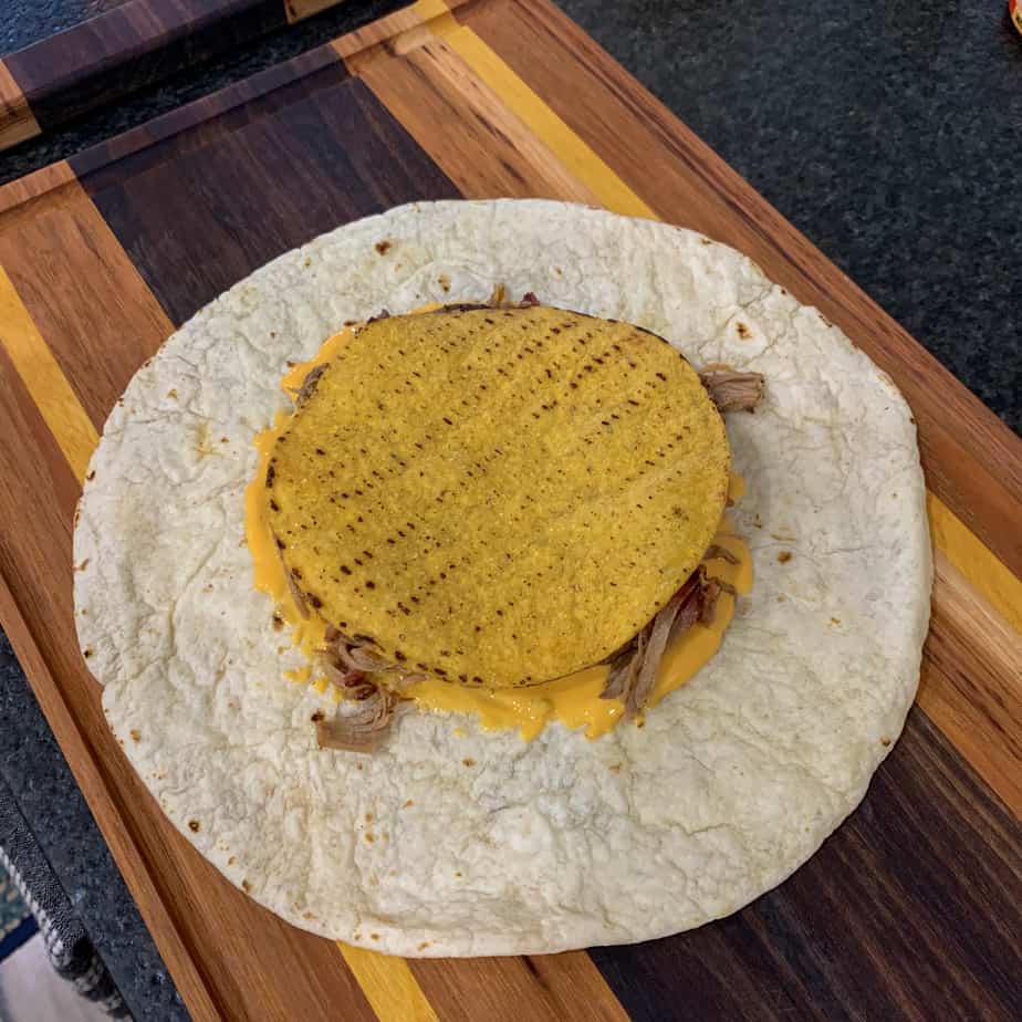 tostada shell over toppings and a tortilla