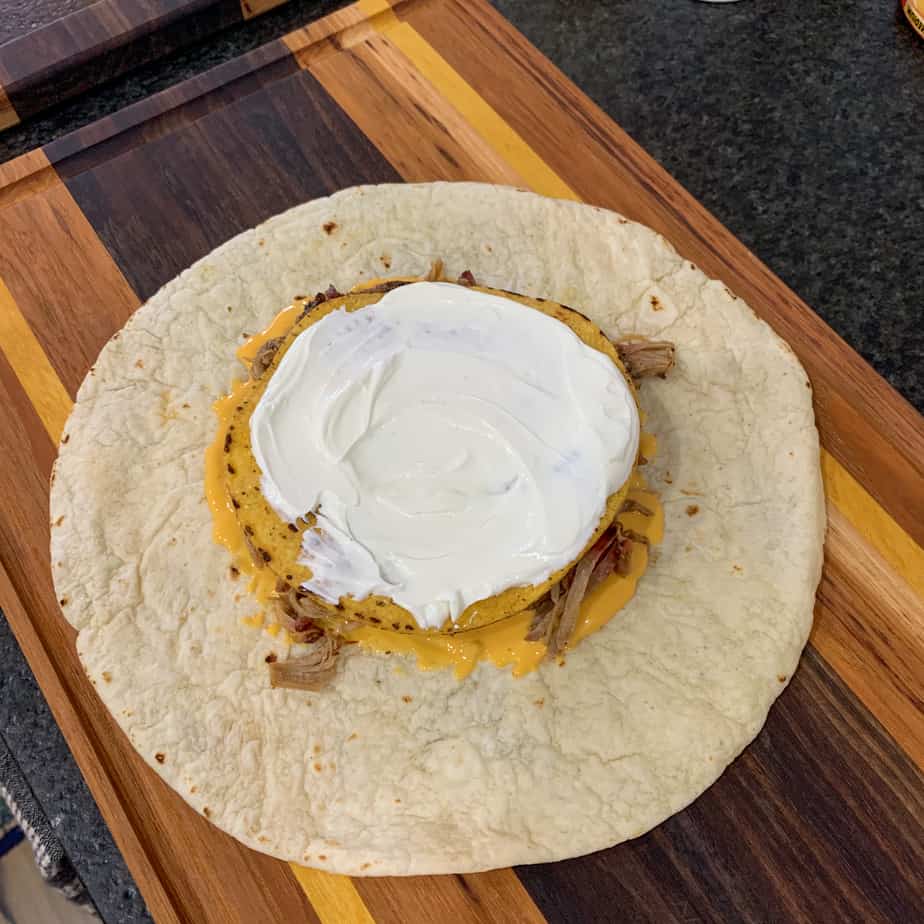 tostada shell topped with sour cream