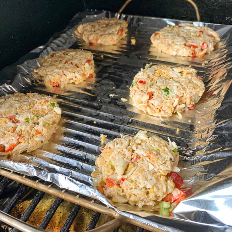 smoked crab cakes on foil in a smoker