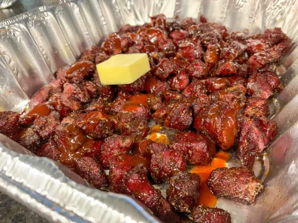 smoked stew meat with butter and bbq sauce