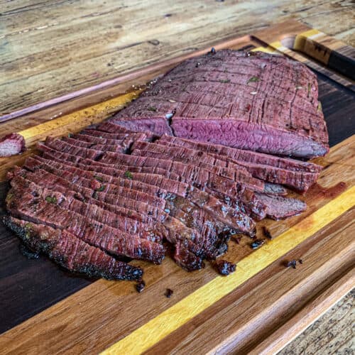 Sliced flank steak on a cutting board