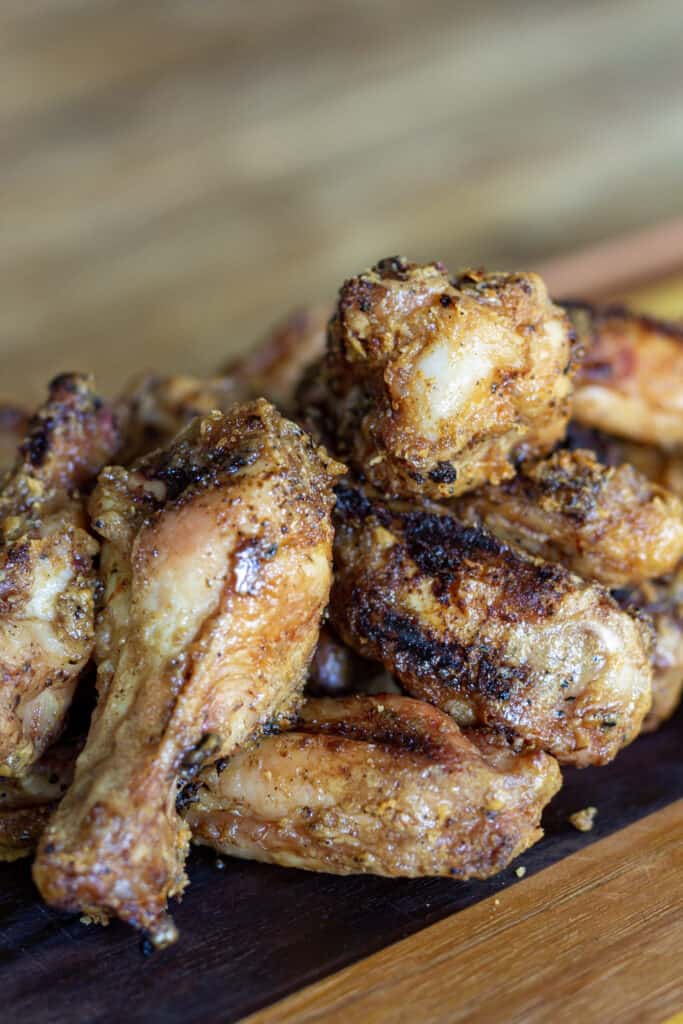 spicy peanut butter chicken wings on a cutting board