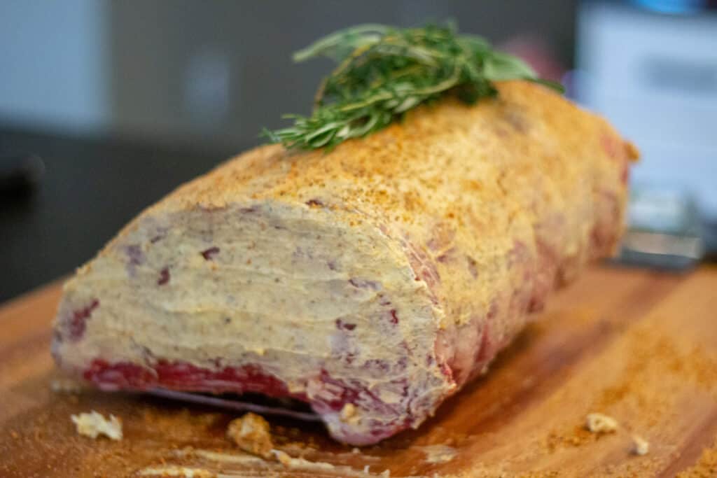 prime rib with compound butter on a cutting board