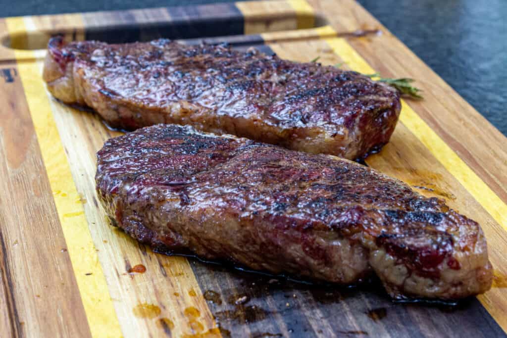 smoked new york strips on a cutting board