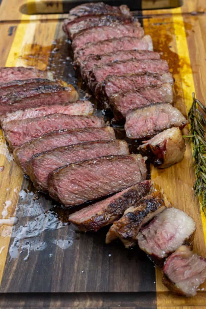 smoked new york strips sliced on a cutting board