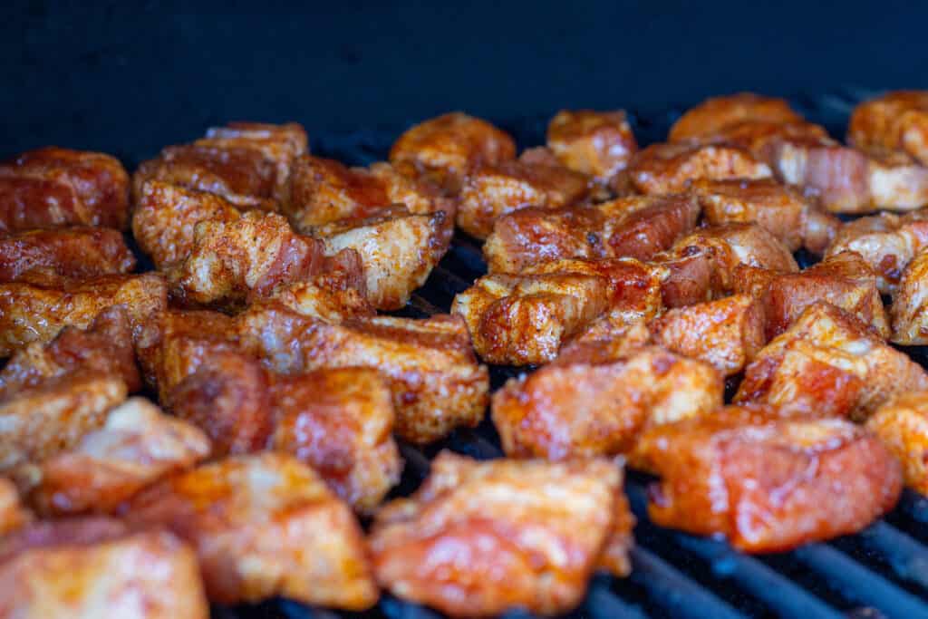 pork belly cubes in a smoker