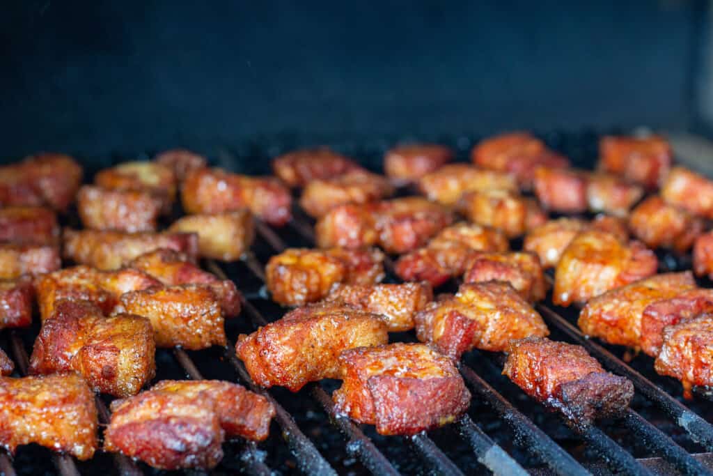 pork belly cubes in a smoker