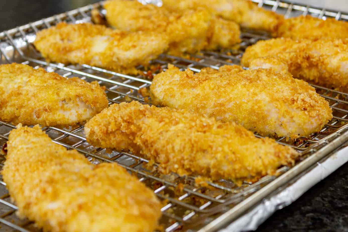 grilled chicken tenders on a grill rack