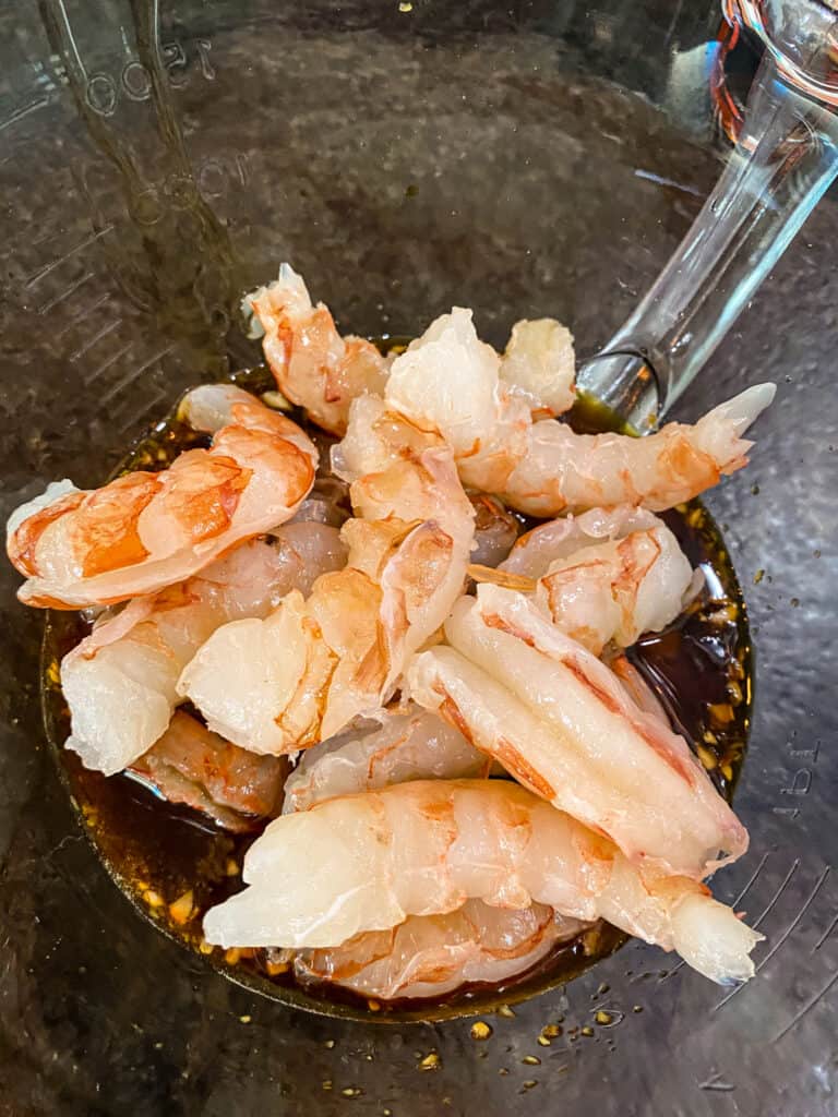 shrimp going in the sweet and spicy grilled shrimp marinade