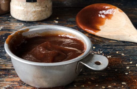 sweet and spicy bbq sauce in a measuring cup