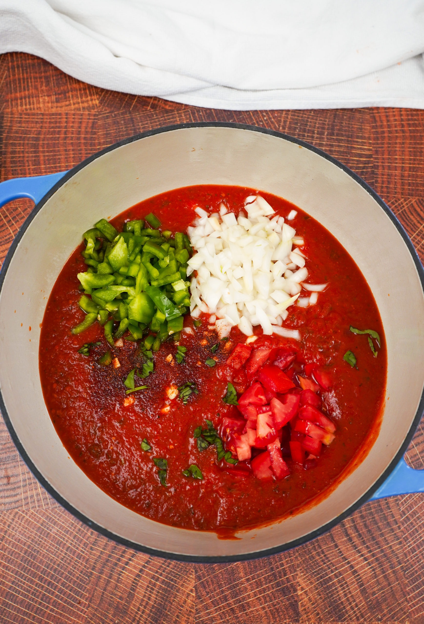 Preparing sauce ingredients in Dutch oven.