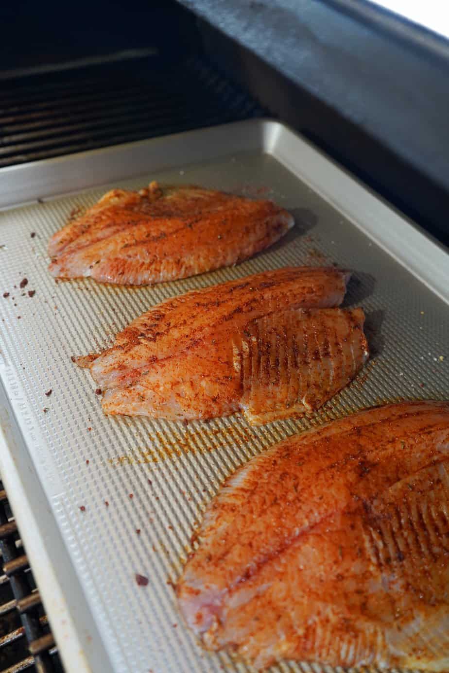 Pan of tilapia in smoker. 