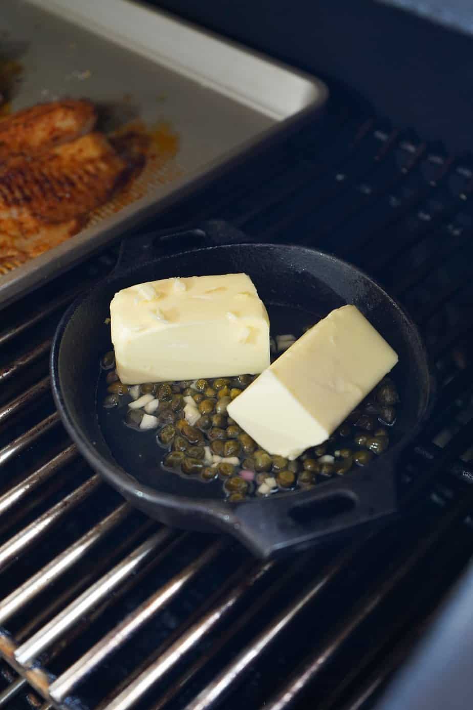 Sauce ingredients in small pan on smoker. 