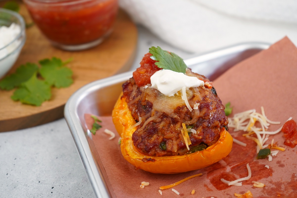 Smoked chorizo stuffed peppers with sour cream and salsa. 