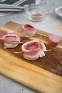 Secure the bacon with a skewer or toothpick through the bottom