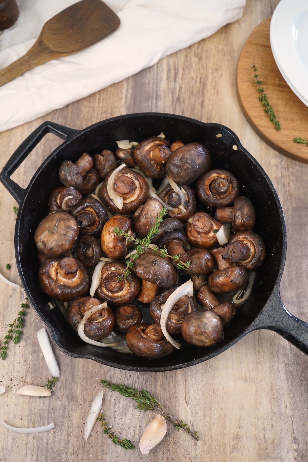 Smoked mushrooms in cast iron skillet with fresh thyme. 