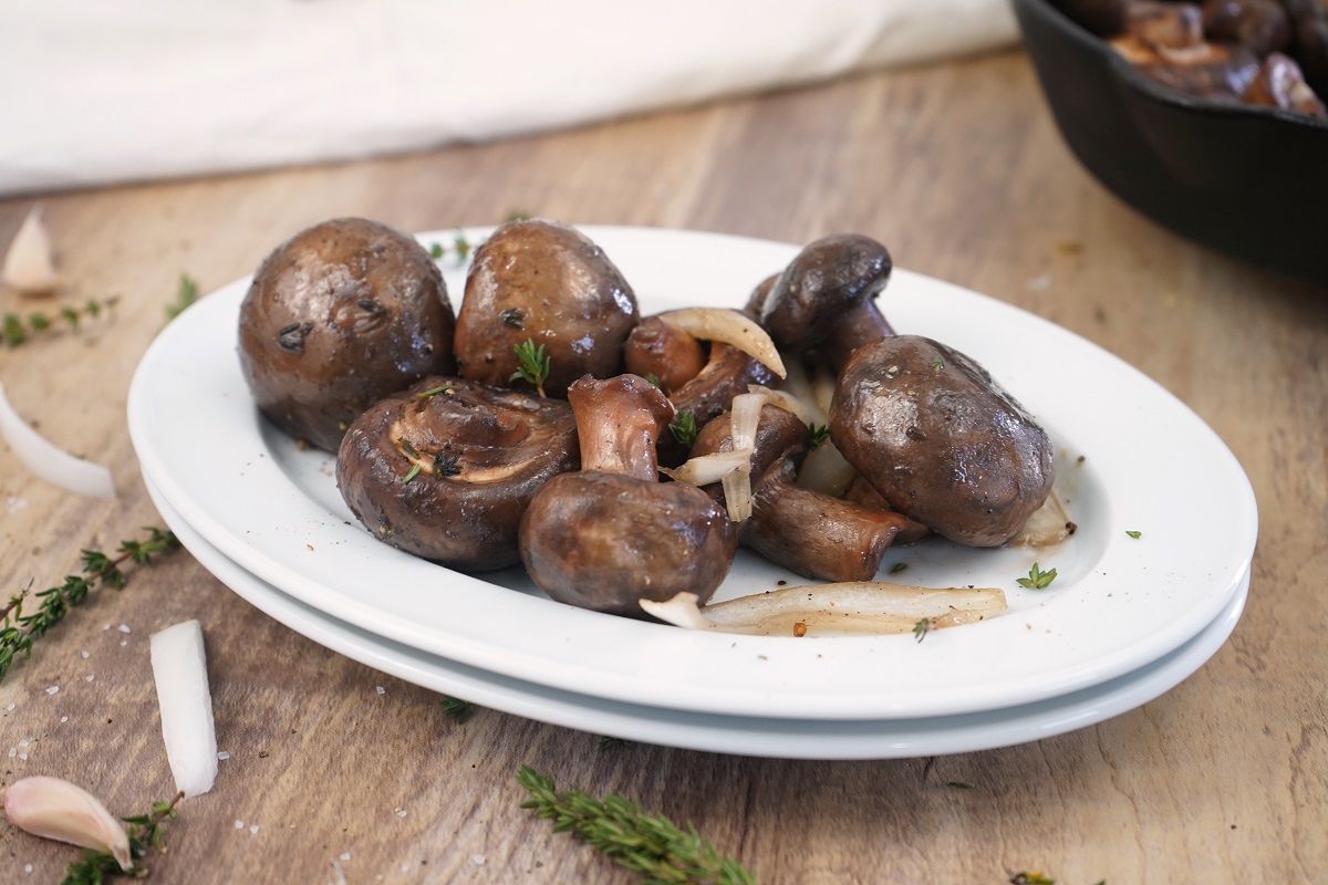 Garlic thyme smoked mushrooms served on a white plate. 