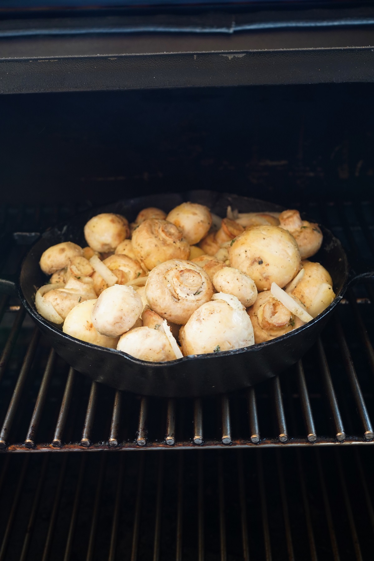 Transfer the pan out to the preheated smoker and place onto the grates