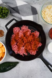 In a cast iron skillet break up the ground beef and season with the Spicy BBQ Rub