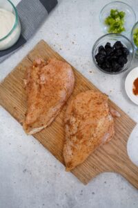 Season both sides of the chicken breasts with the BBQ rub and rub it in