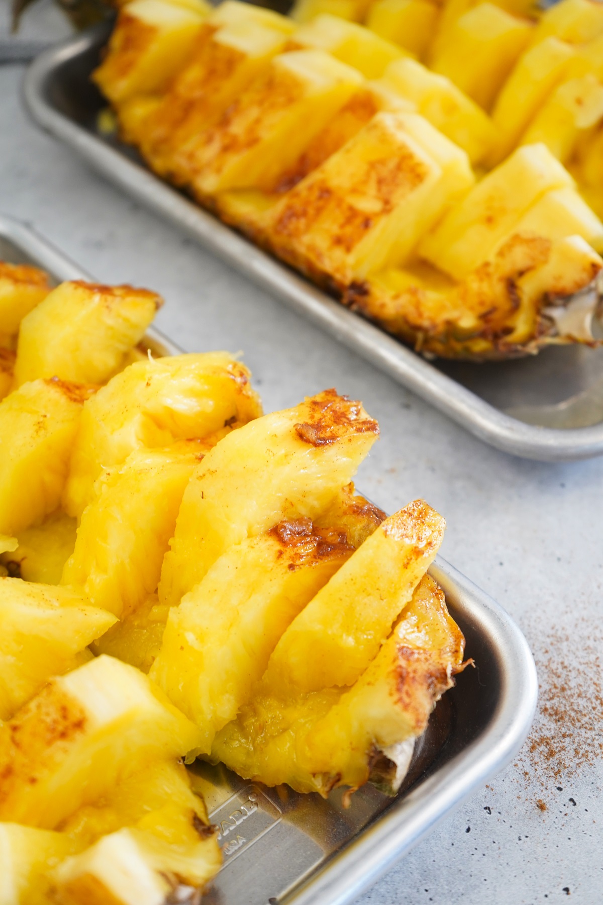 Smoked pineapple slices with cinnamon and honey on platter. 
