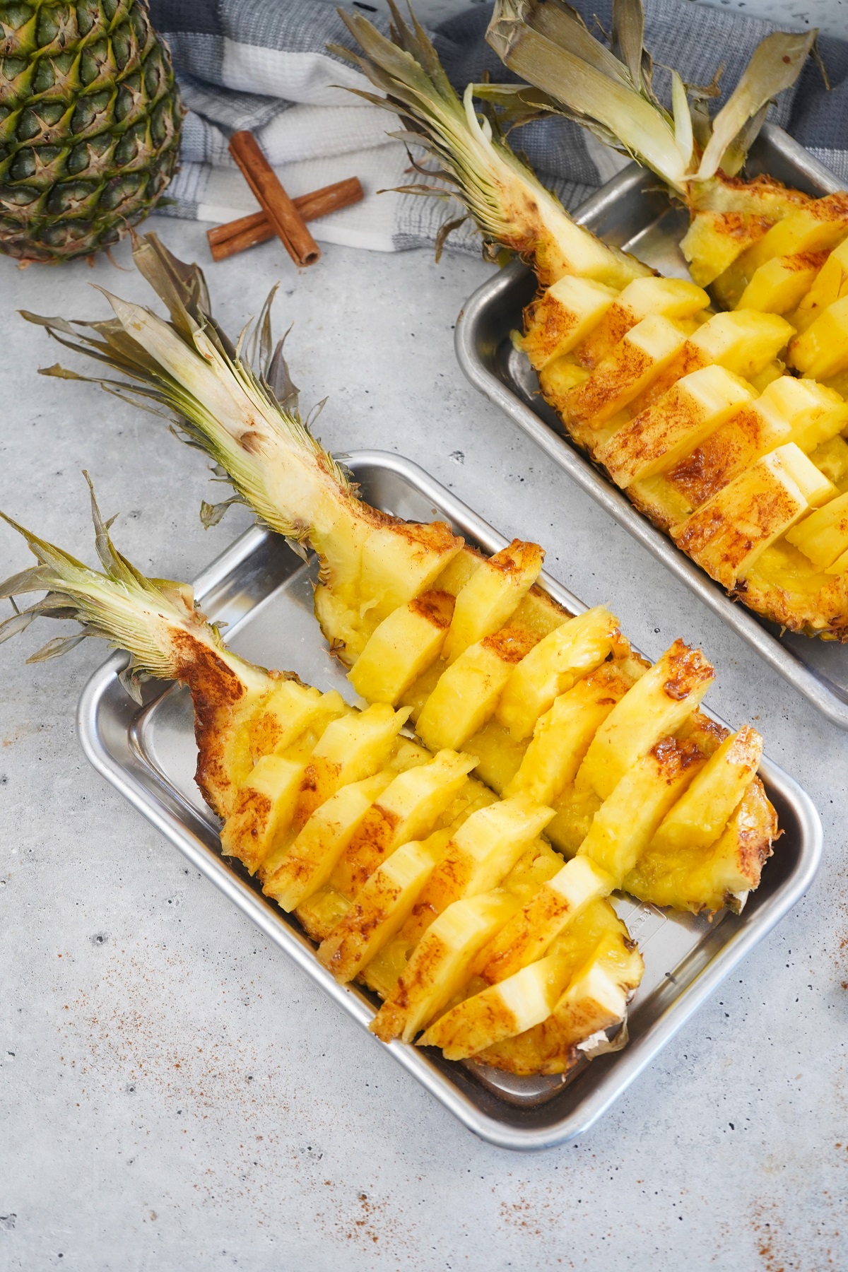 Smoked pineapple boats on silver platter. 