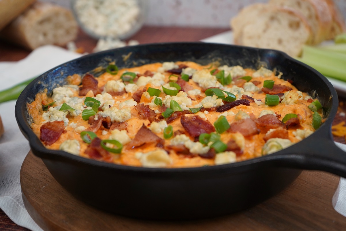 Hot buffalo chicken dip with bacon and green onions. 