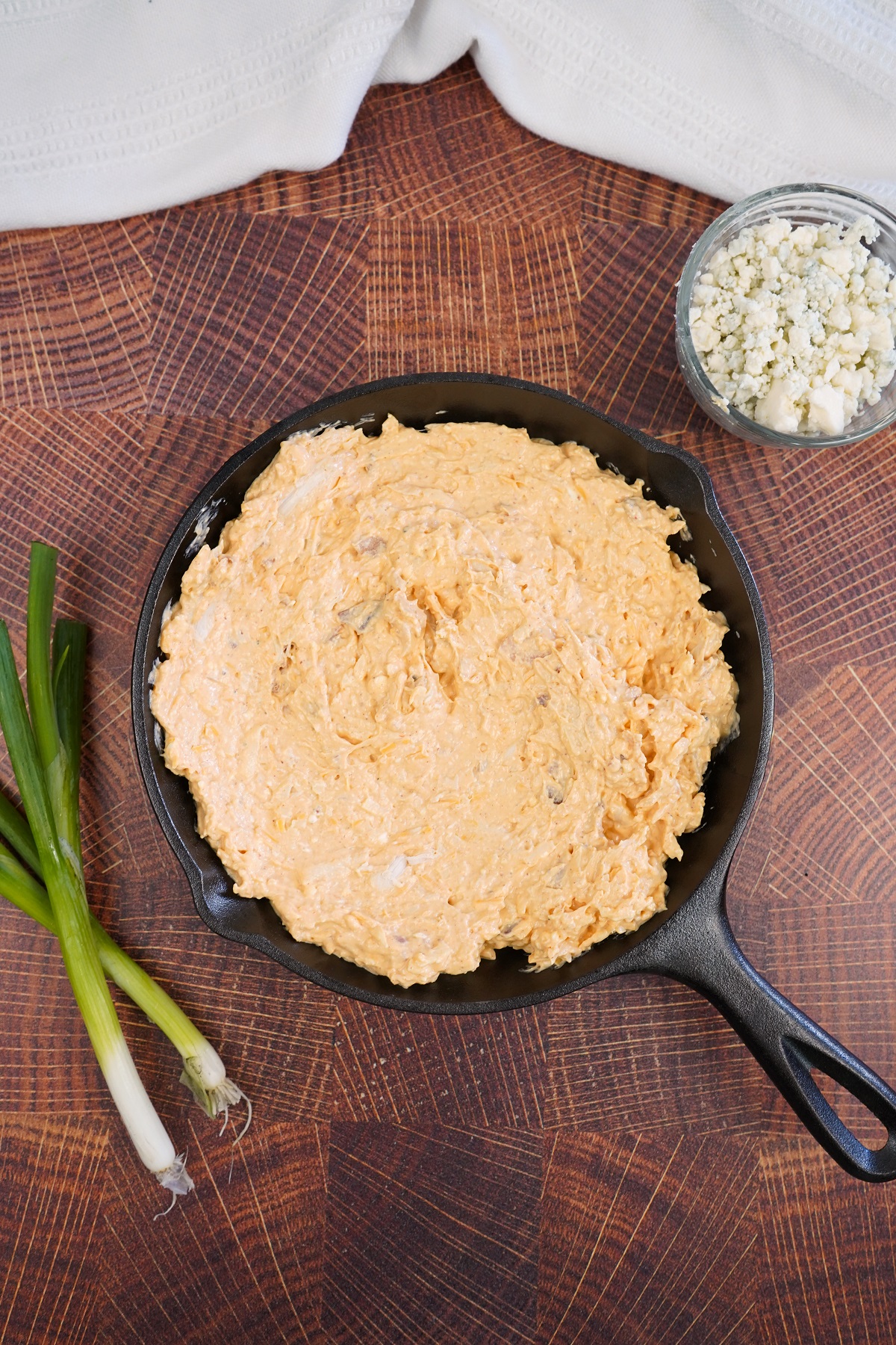 Smoked buffalo chicken dip in skillet before cooked. 