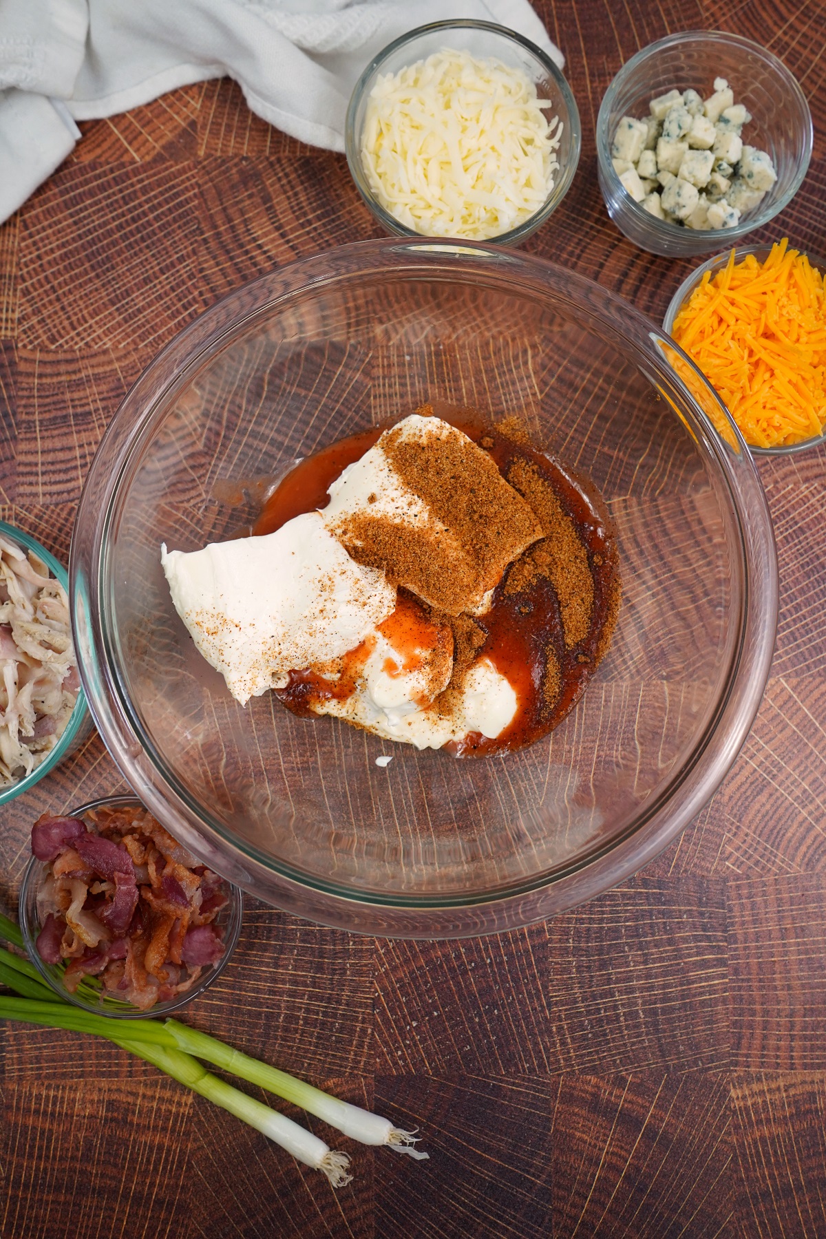 Combined ingredients for buffalo chicken dip in bowl. 