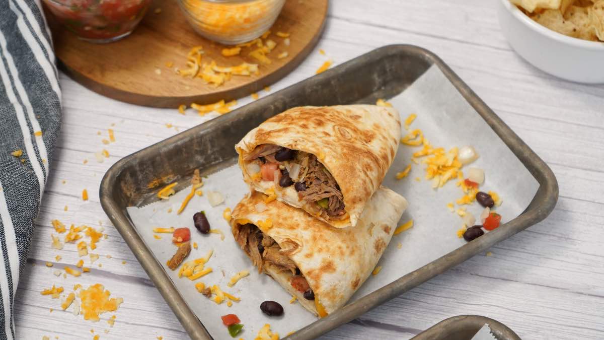Burritos stacked with cheese, beans, and pico