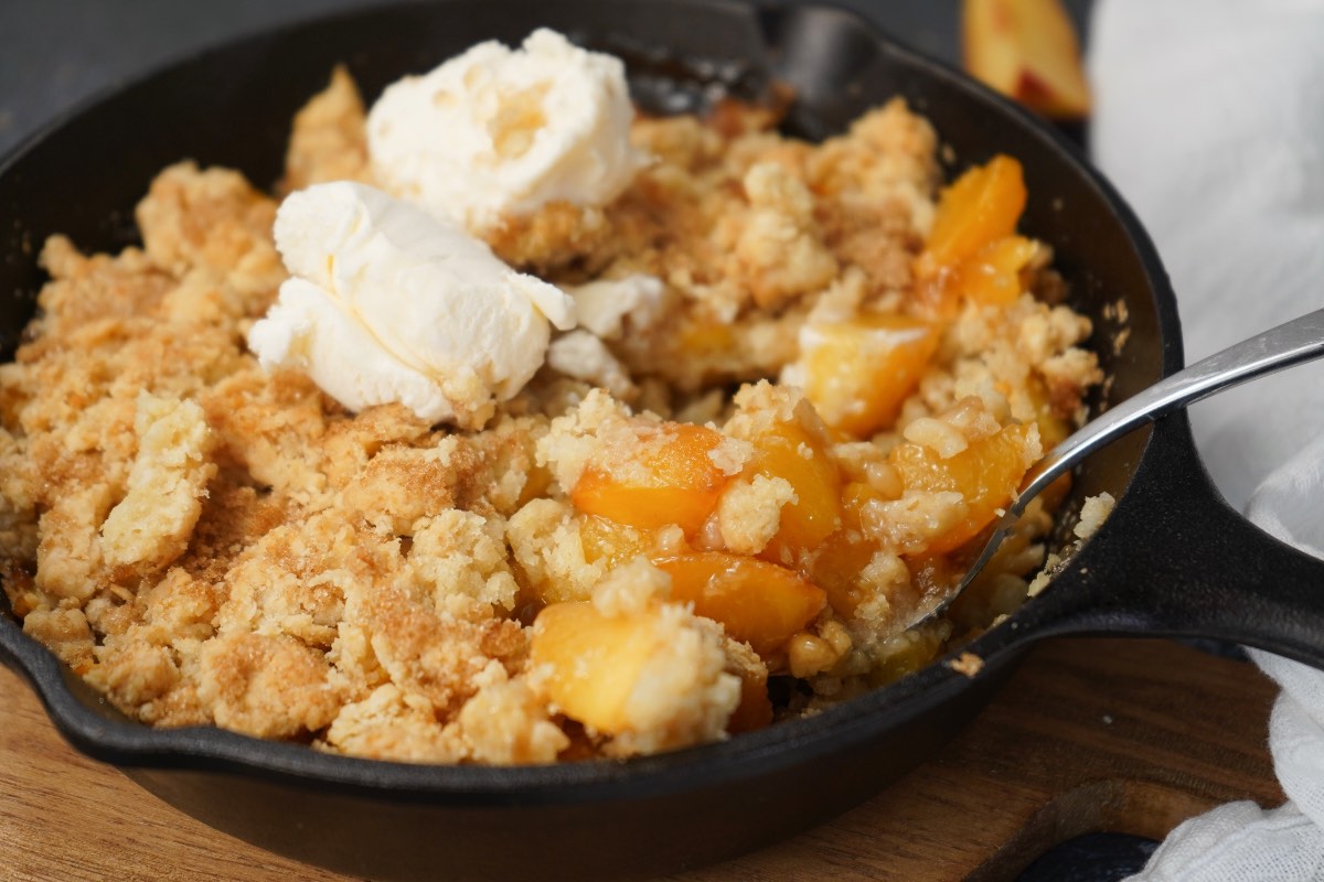 Spoon in peach cobbler