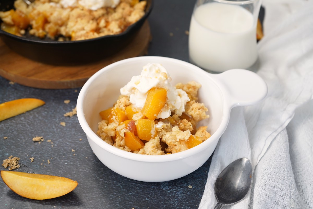 White bowl with peach cobbler