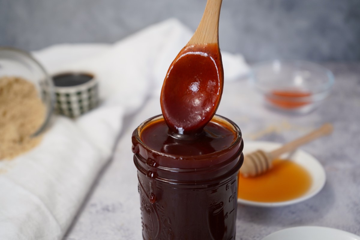Sweet and spicy bbq sauce on wooden spoon