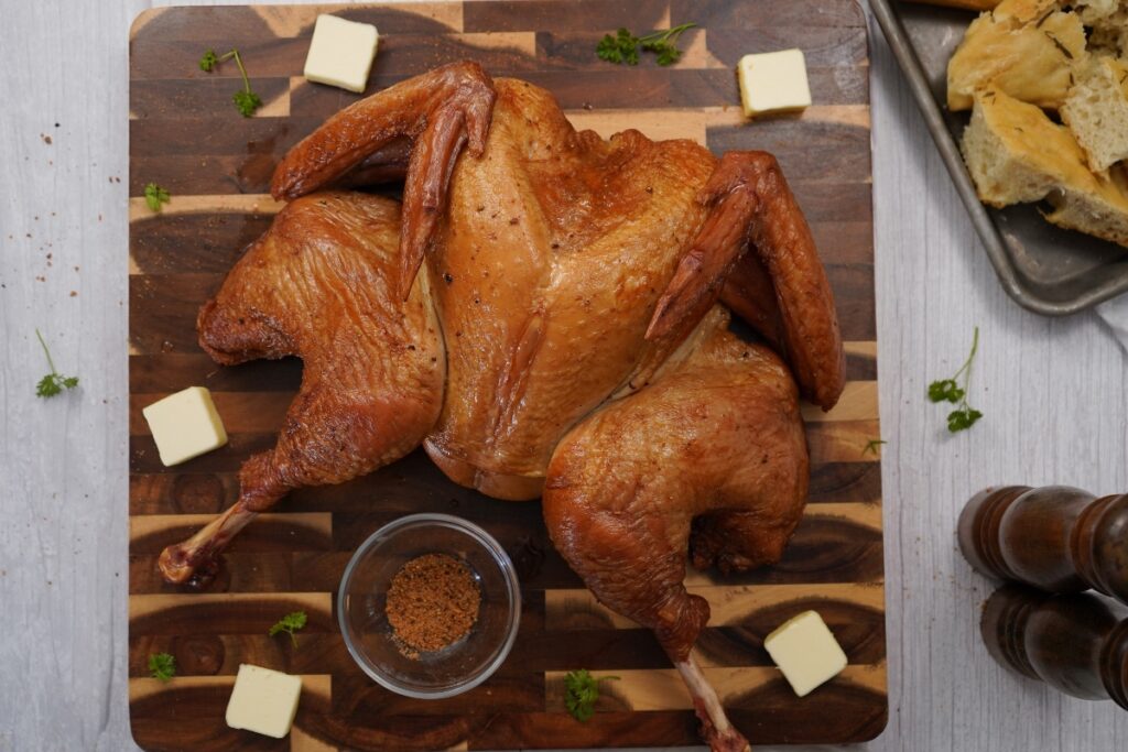 Smoked Spatchcock Turkey on cutting board.
