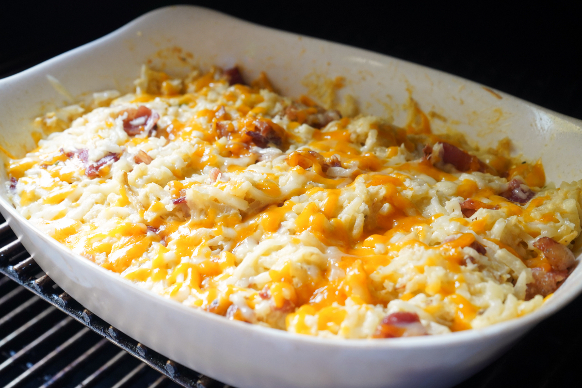 Cheesy potatoes on smoker grate